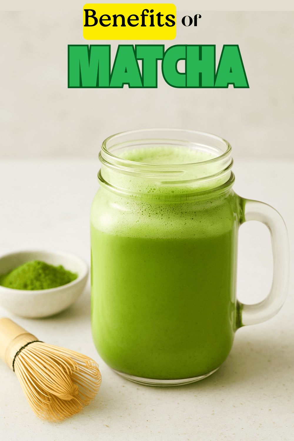 Frothy iced matcha latte being whisked cold in a cup, ready to pour over ice.